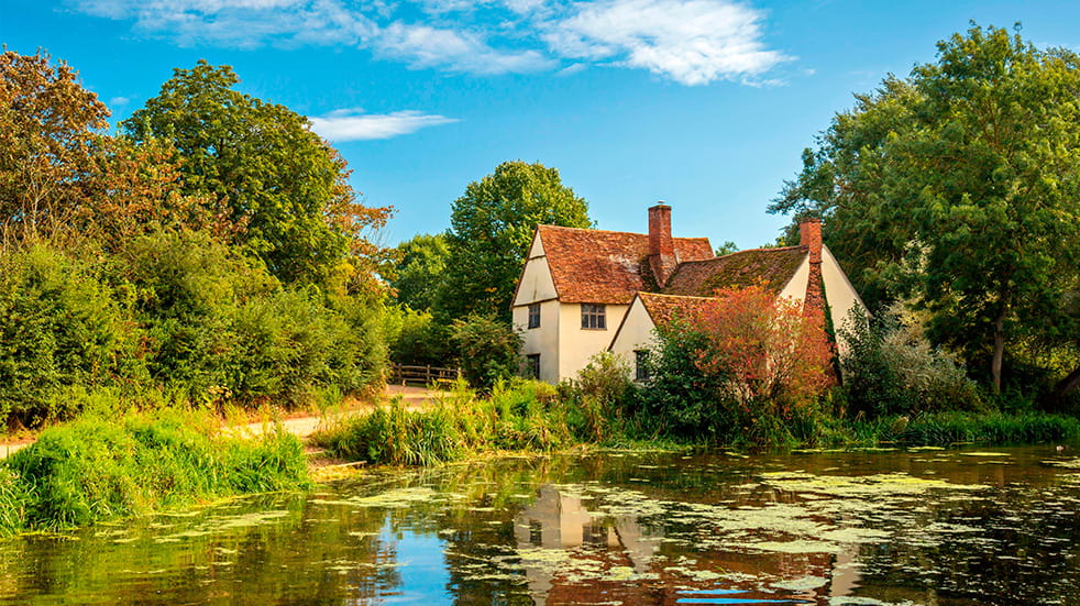 A stunning landscape of National Trust property Flatford Mill across the River Stour in East Suffolk